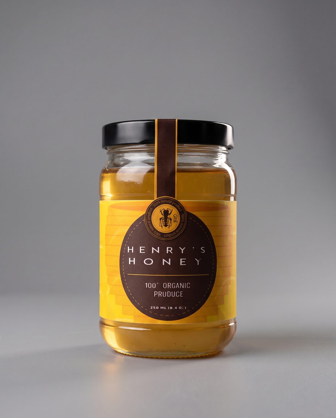A jar of Henry's Honey on a grey studio surface